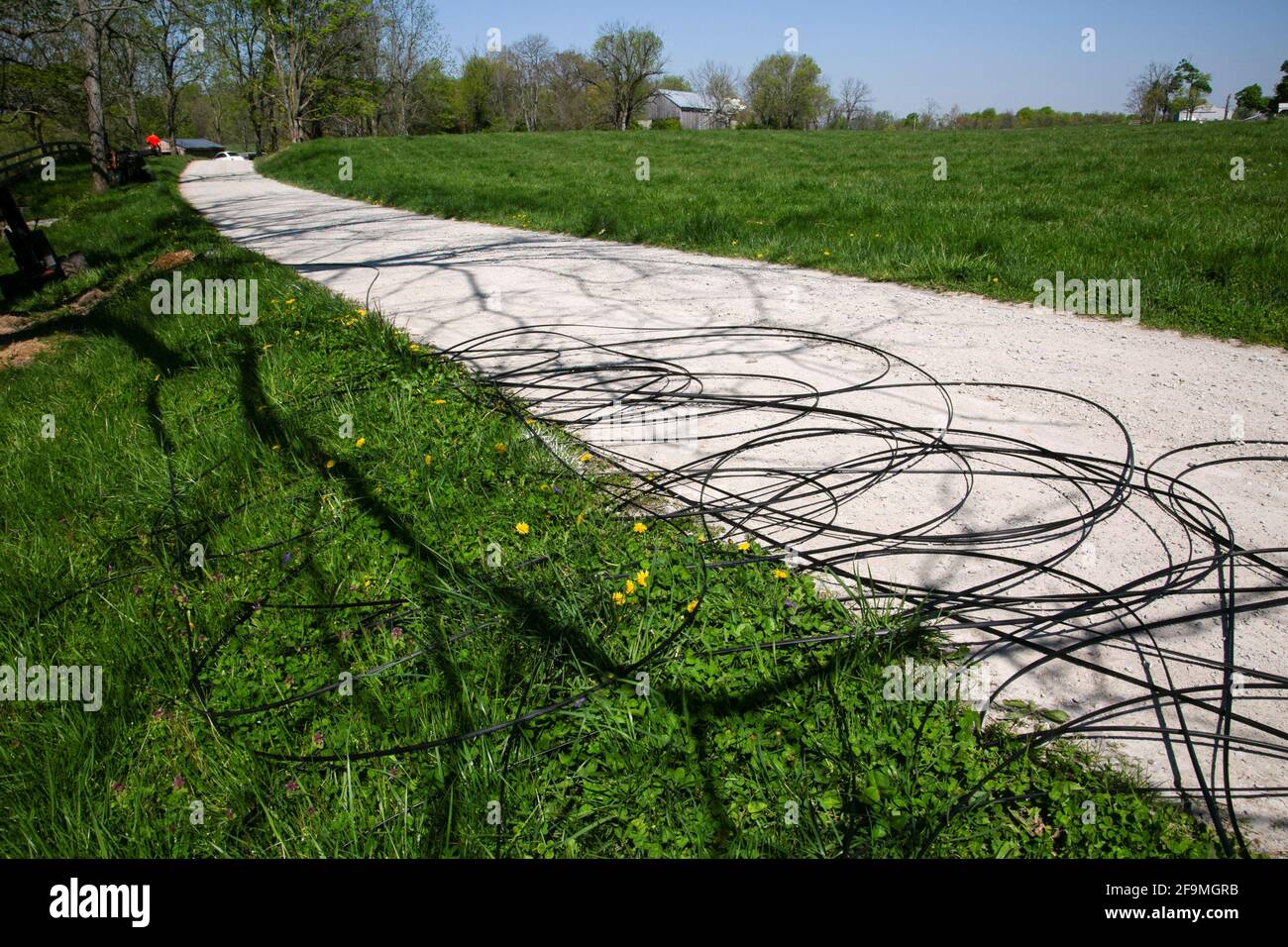 Fiber cables sit on the ground ready to be dug underground in