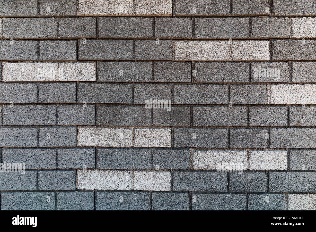brick wall texture in gray tones with some white bricks Stock Photo