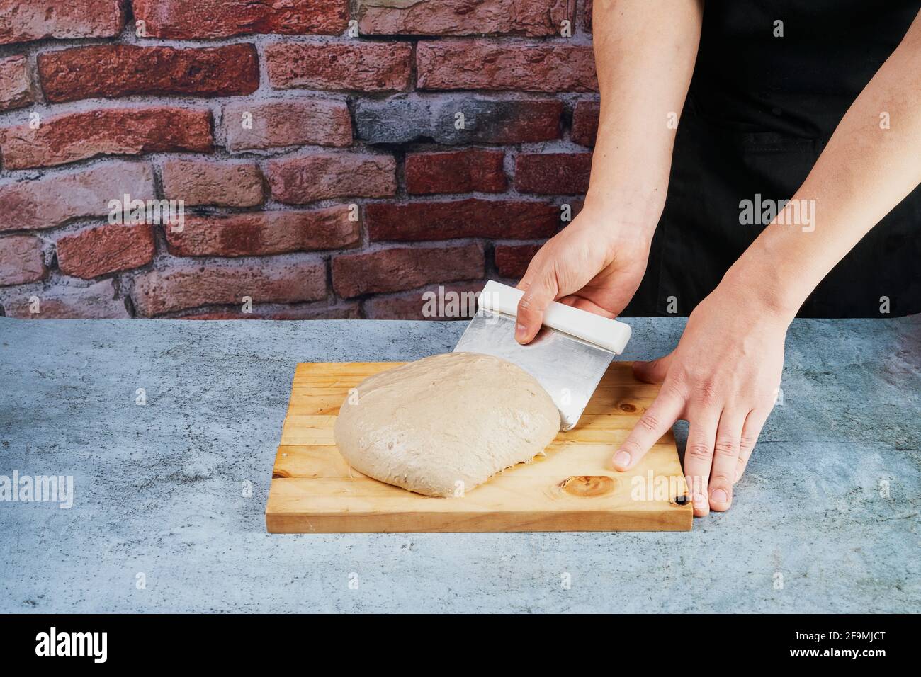 Baker preparing the dough for the artisan bread Stock Photo