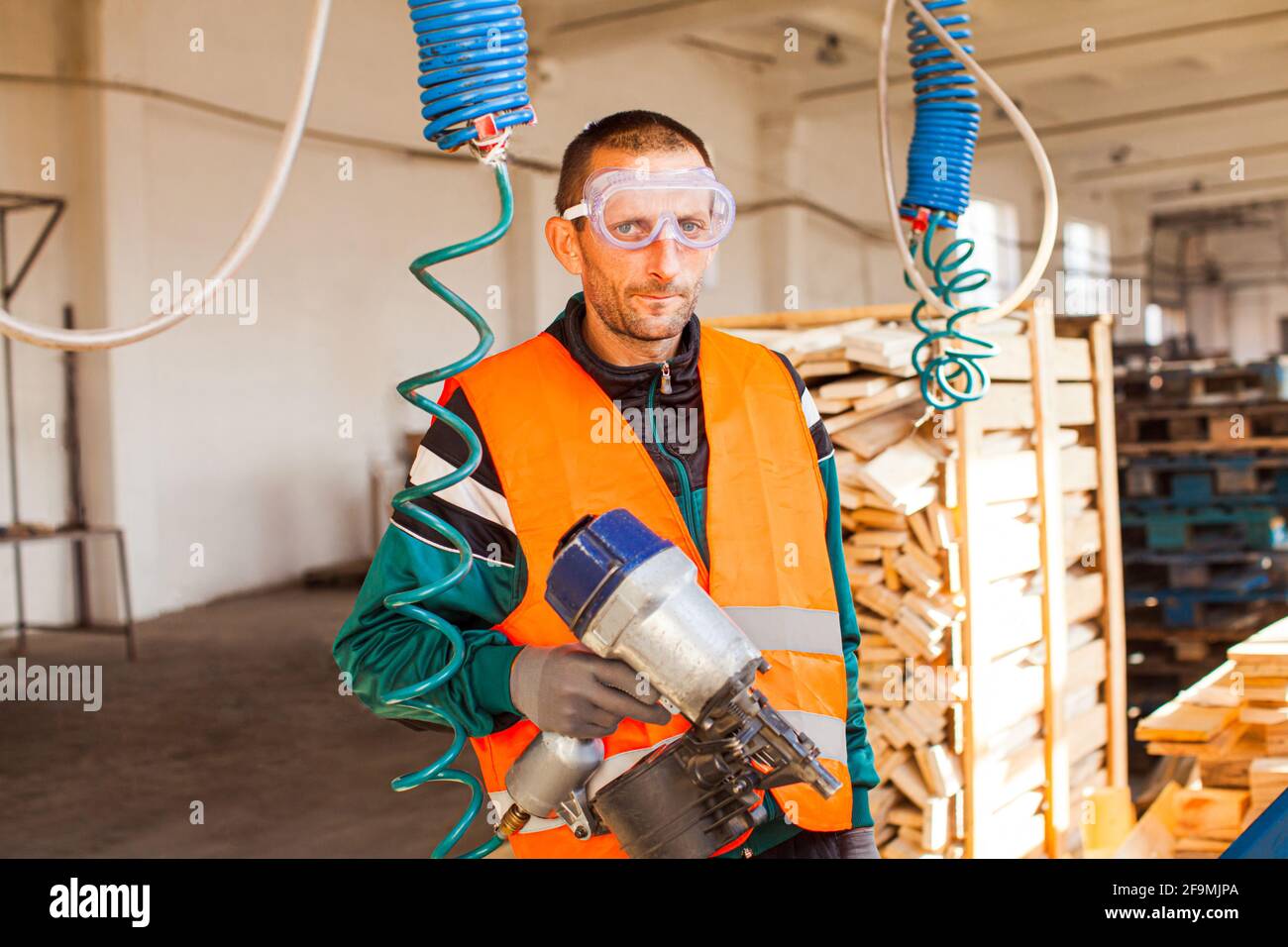 Young hardworking man on a woodwork factrory Stock Photo