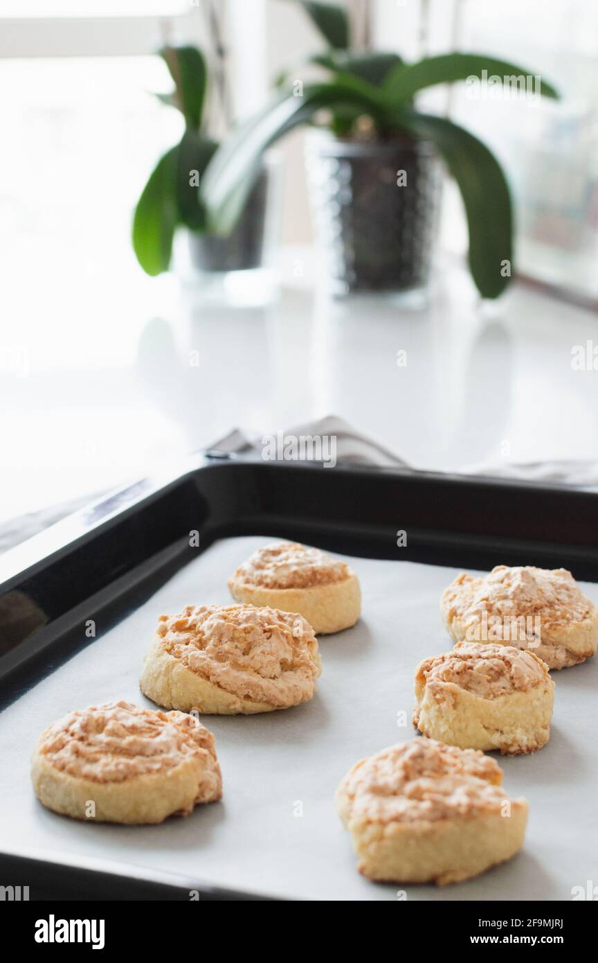 Cookies in a baking sheet on countertop against the window and p Stock Photo