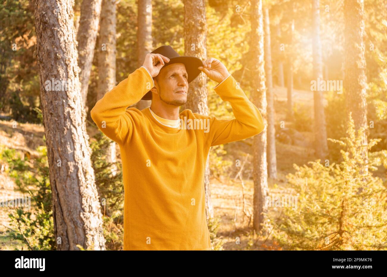 Young stylish man in hat in the forest.Portrait caucasian traveler