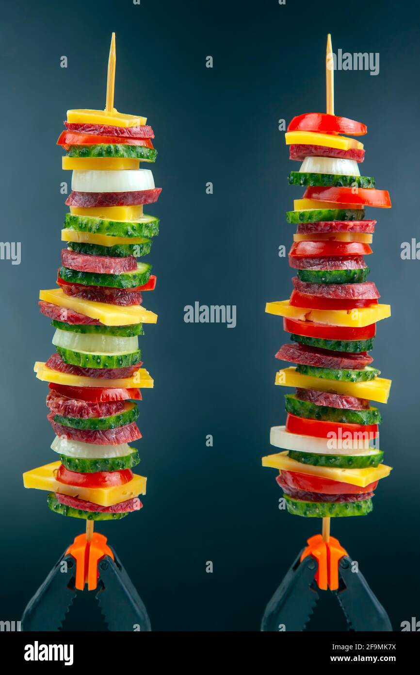 sliced pieces of sausage, salami, cheese, cucumber and tomato. fast food. ingredients for pizza