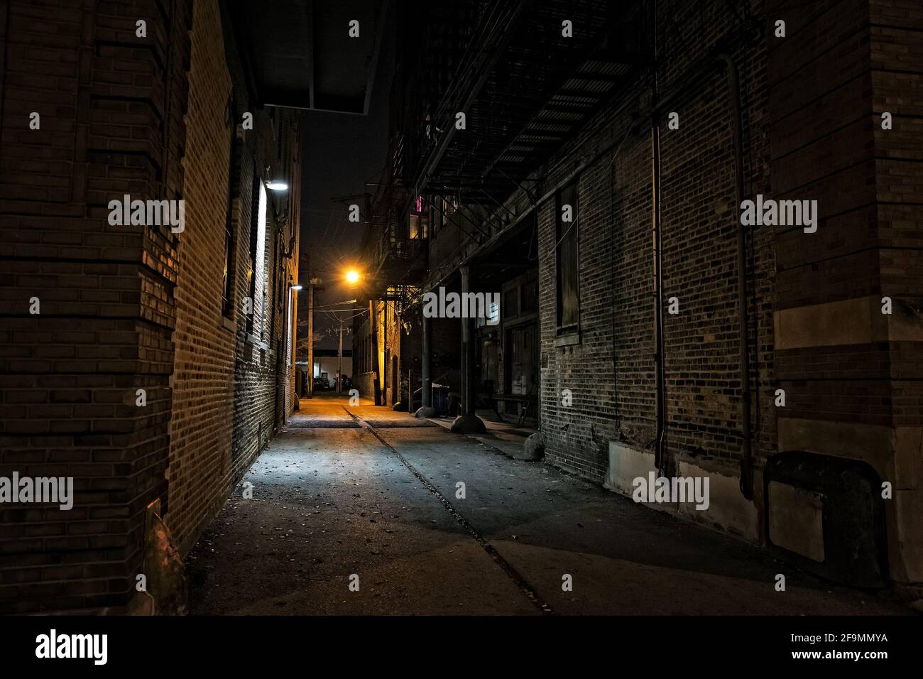Dark urban city alley at night Stock Photo