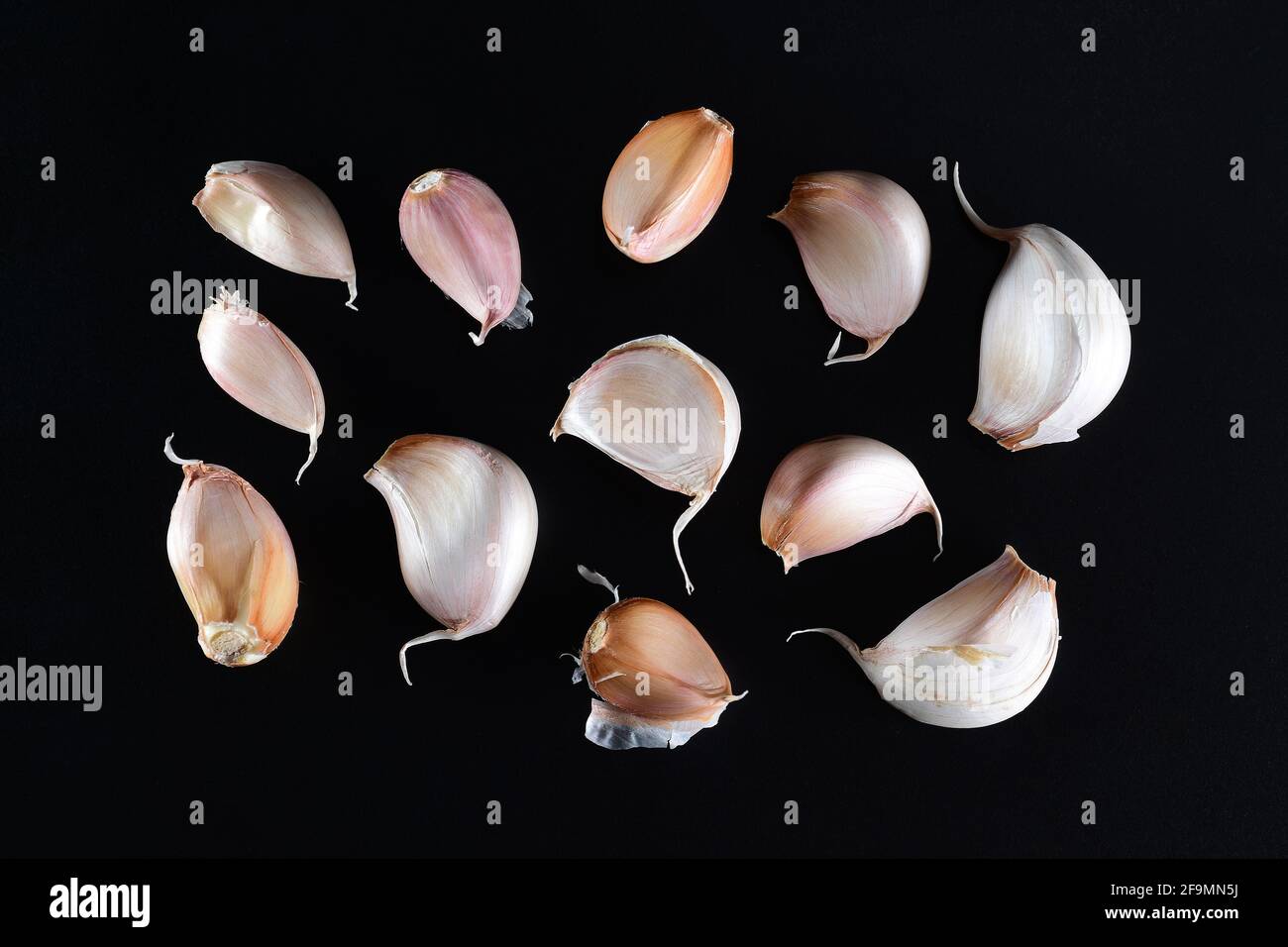 Image of garlic cloves studio isolated on dark background, view above Stock Photo