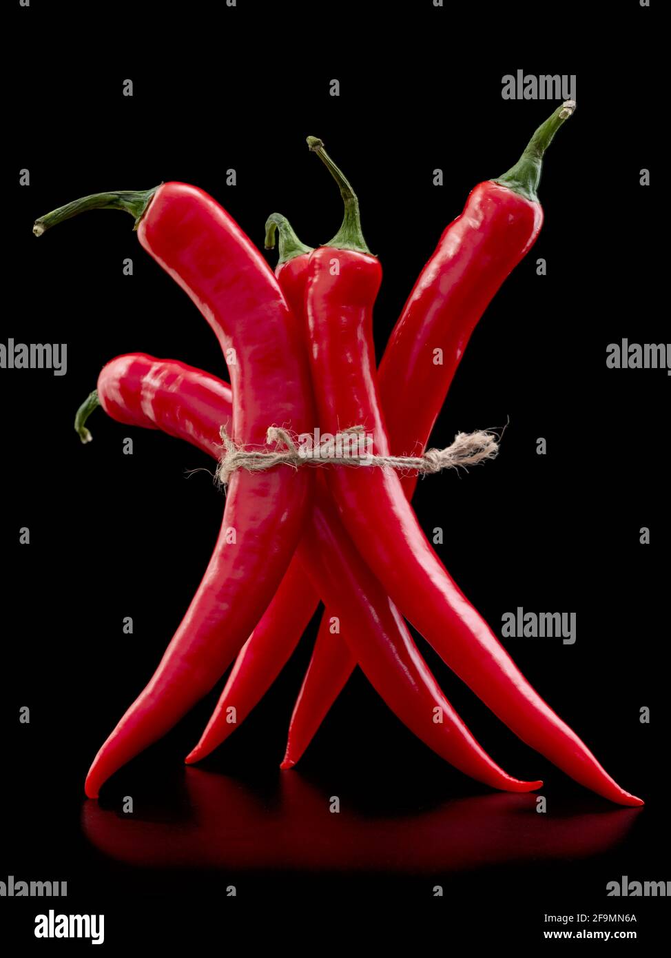 Cayenne, long red chili peppers on dark background Stock Photo