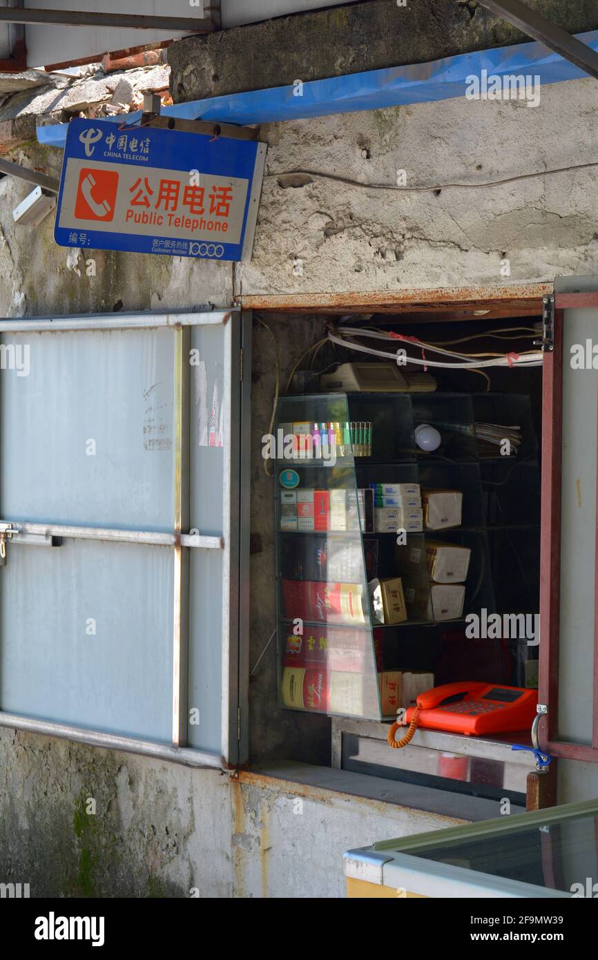 Old fashioned public telephone in a community of China. This was a common sight before everyone had multiple mobile phones. Unusual to see in 2021. Stock Photo