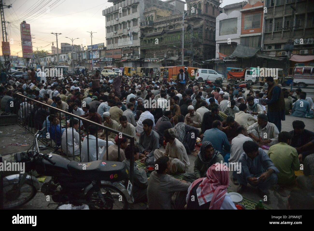 Rawalpindi, Pakistan. 19th Apr, 2021. Faithful Muslims are breaking the fast (Iftar) at roadside during the Holy month of Ramadan-ul-Mubarak. (Photo by Zubair Abbasi/Pacific Press) Credit: Pacific Press Media Production Corp./Alamy Live News Stock Photo