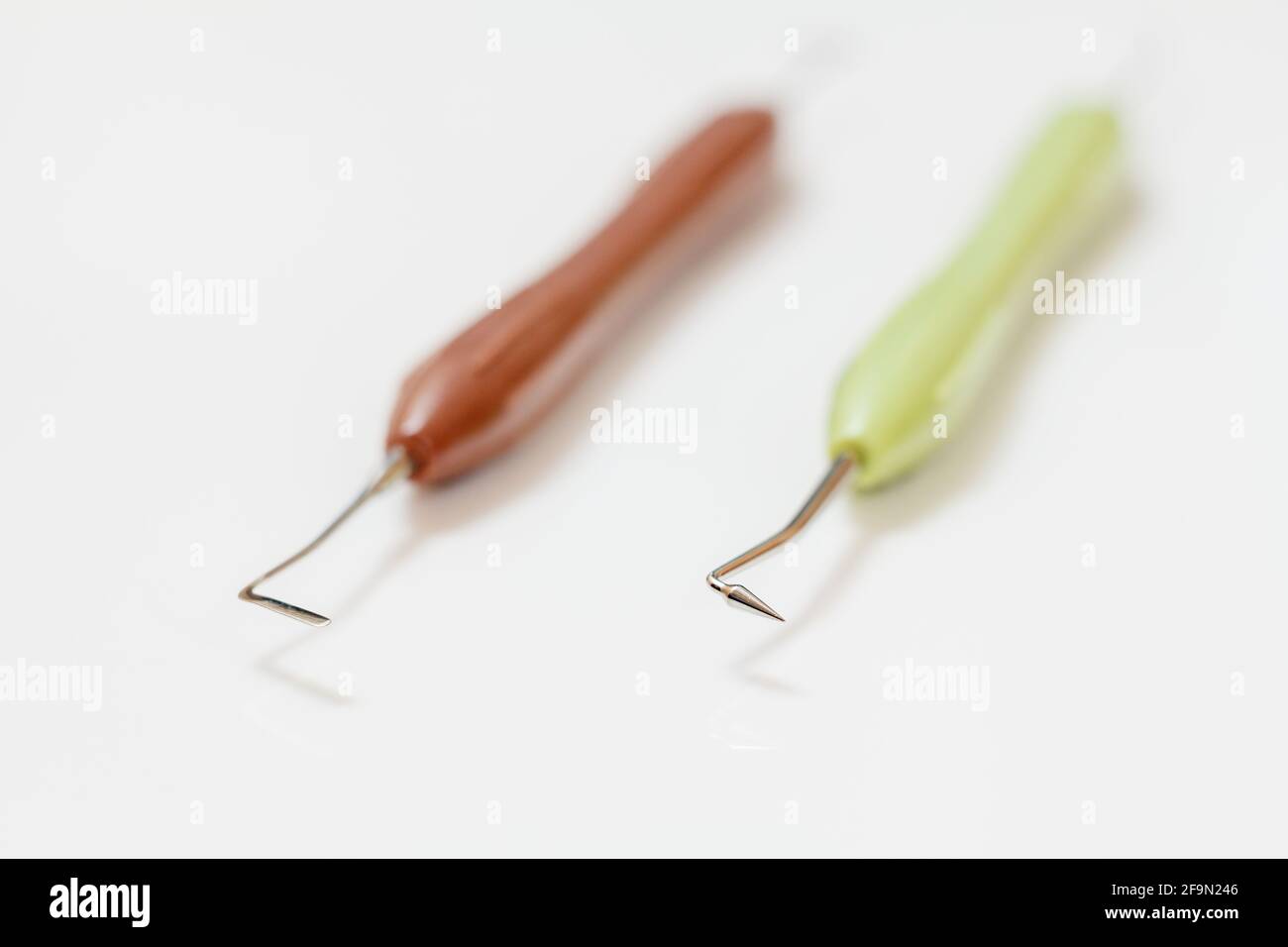 Set of metal dental instruments for dental treatment. Dental Composite Filling and Restorative Instruments with Plastic Handle on the white background Stock Photo