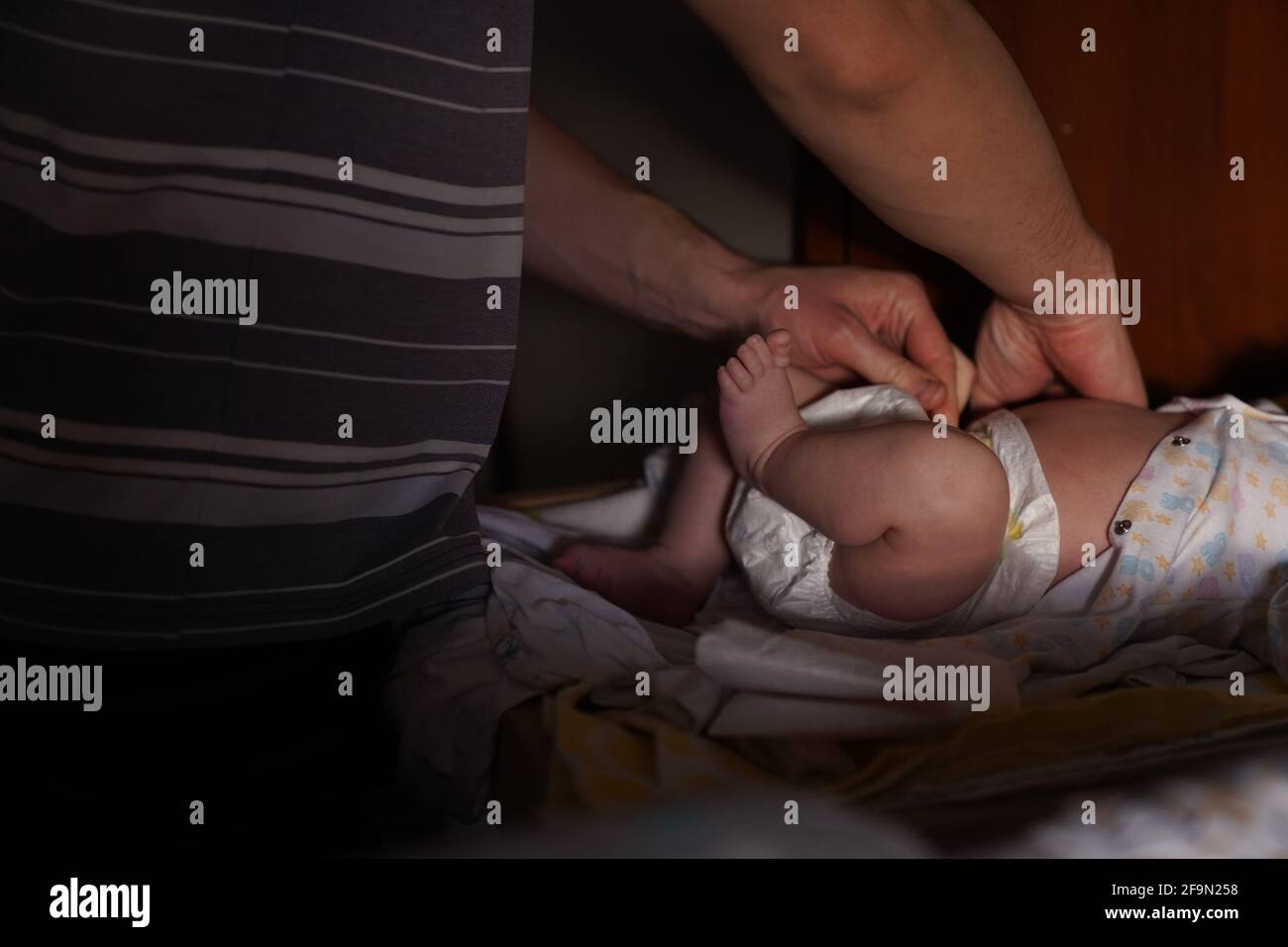 Father changes diaper to newborn son. Fatherhood. High quality photo Stock Photo