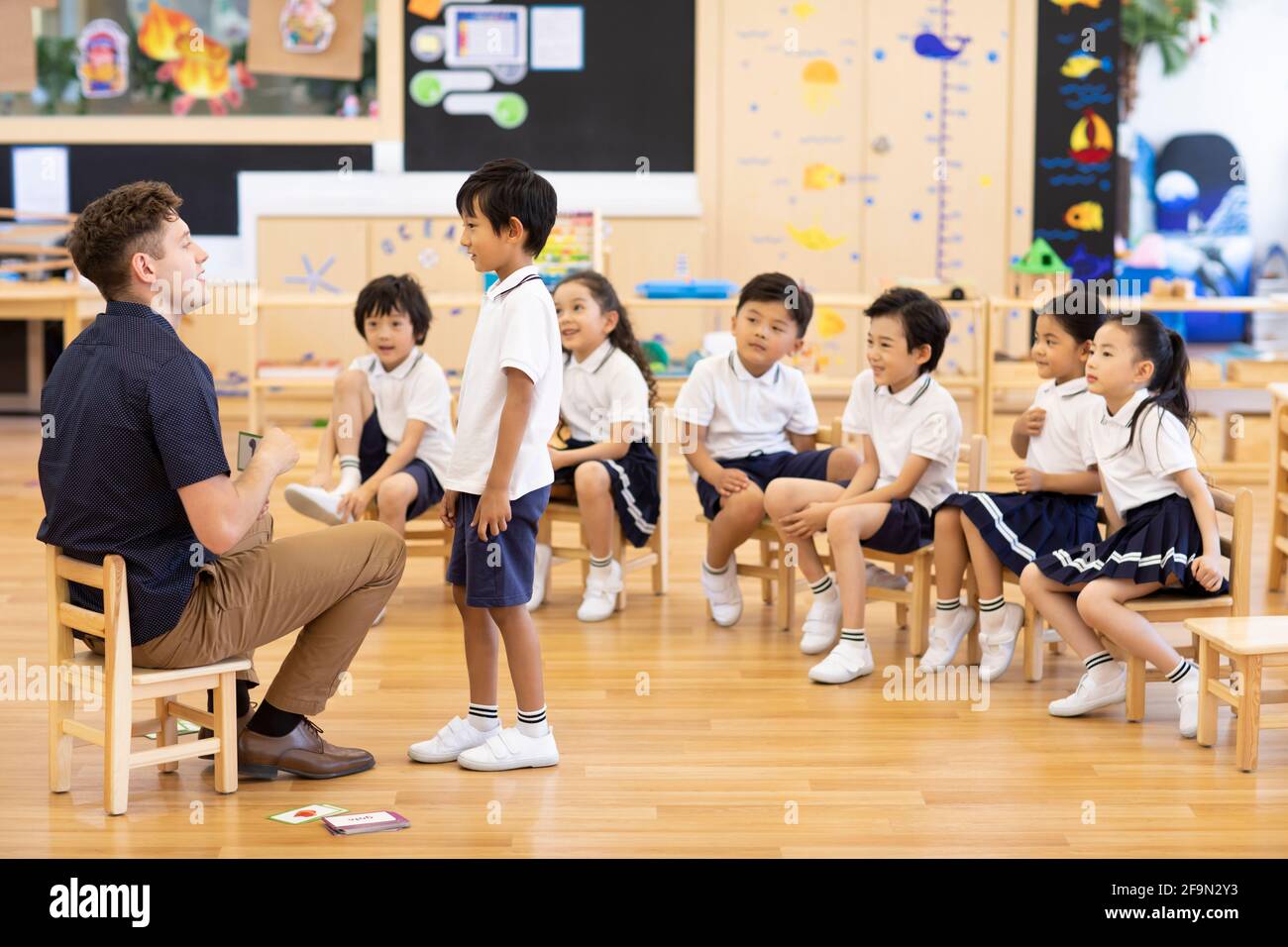 Foreign teacher teaching children English in classroom Stock Photo Alamy