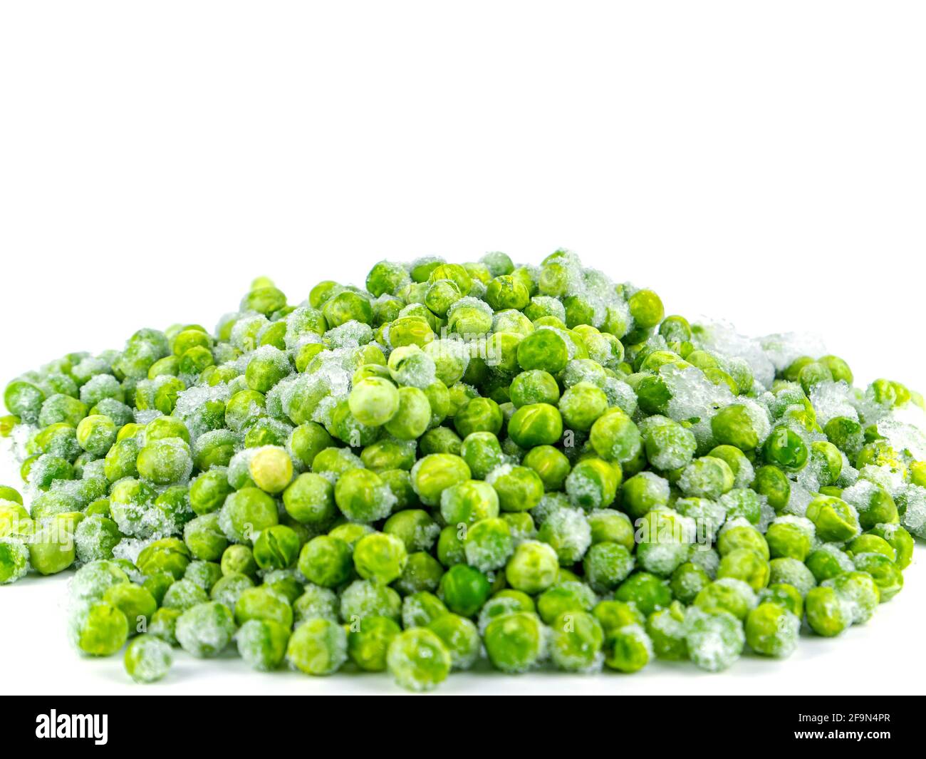 Frozen green peas vegetable on a white plate. Stock Photo