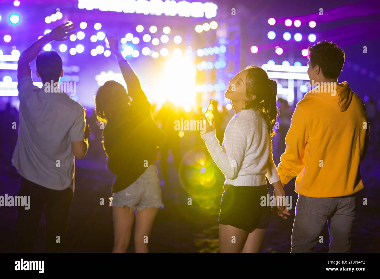 Happy young friends at music festival Stock Photo - Alamy