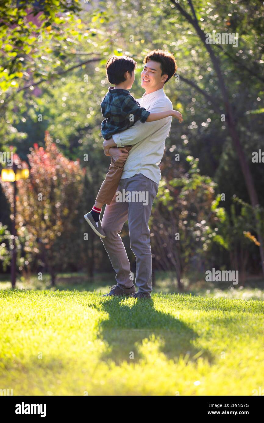 Happy father and son relaxing in park Stock Photo - Alamy