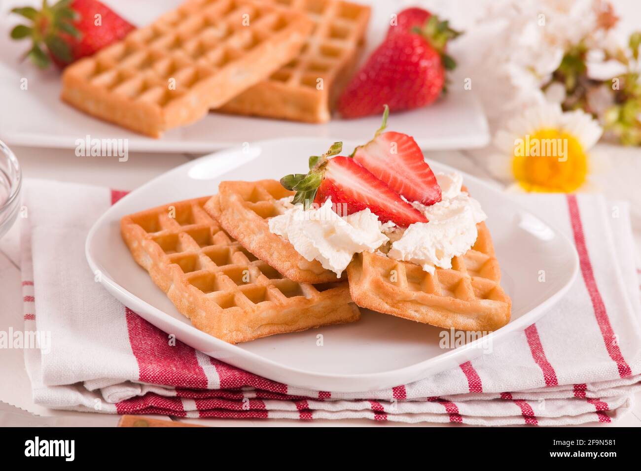 Waffles with strawberries and whipped cream Stock Photo - Alamy