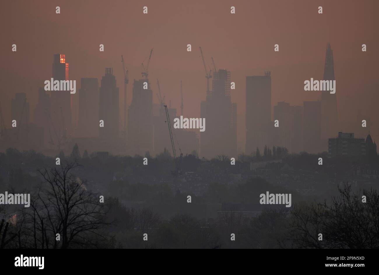 London Uk April 21 Thin Low Lying Mist In The Suburbs Obscures London Skyscrapers On The Skyline Before Another Day Of Sun In The Capital The Rising Sun Strikes The Top
