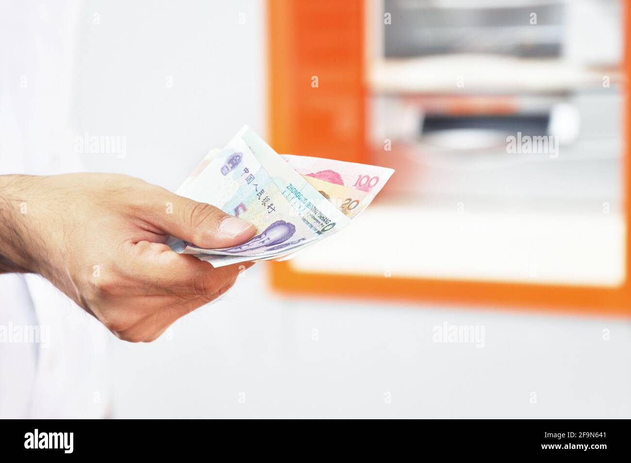 Hand holding money - Chinese renminbi yuan banknotes Stock Photo - Alamy
