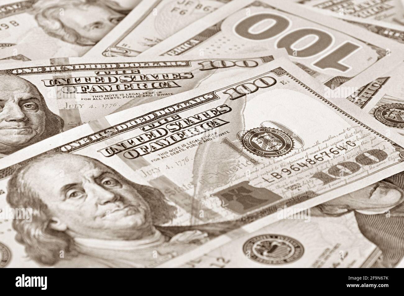Money - 100 United States dollars (USD) bills - focusing on words THE UNITED STATES OF AMERICA Stock Photo