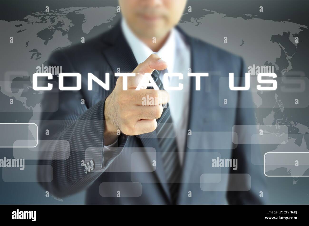 Businessman pointing to CONTACT US sign on virtual screen Stock Photo