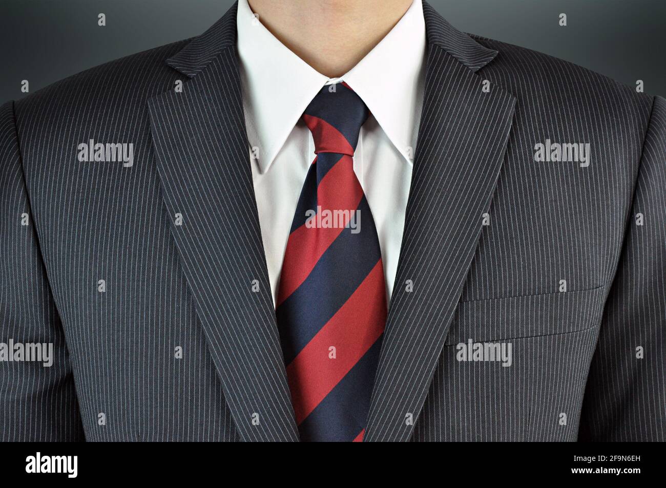 A man wearing suit with stripe necktie - business attire Stock Photo