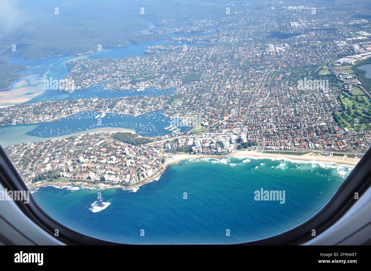 Aerial view of the city near seacoast from window of the airplane Stock Photo