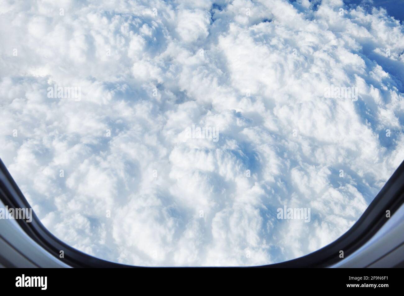 Cloudscape - aerial view of puffy clouds from window of the airplane ...
