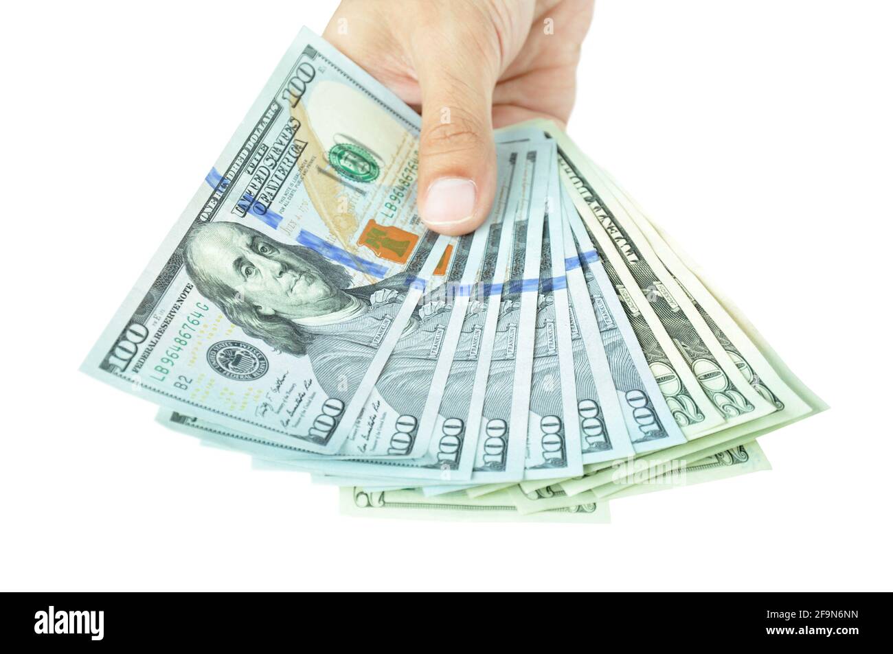 Money - hand holding banknotes - United States Dollars or USD Stock Photo