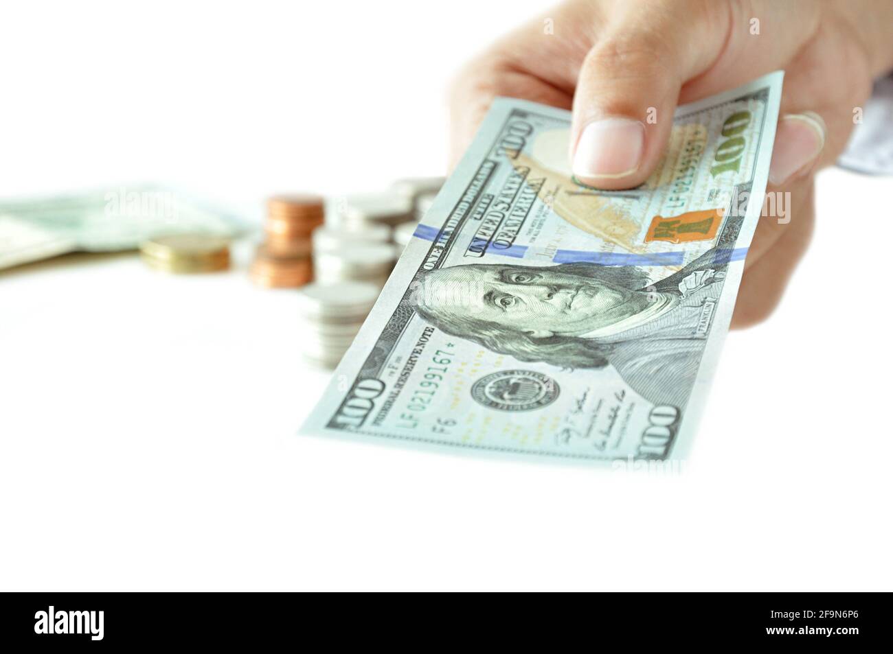 Hand giving money - 100 United States Dollars (or USD) Stock Photo