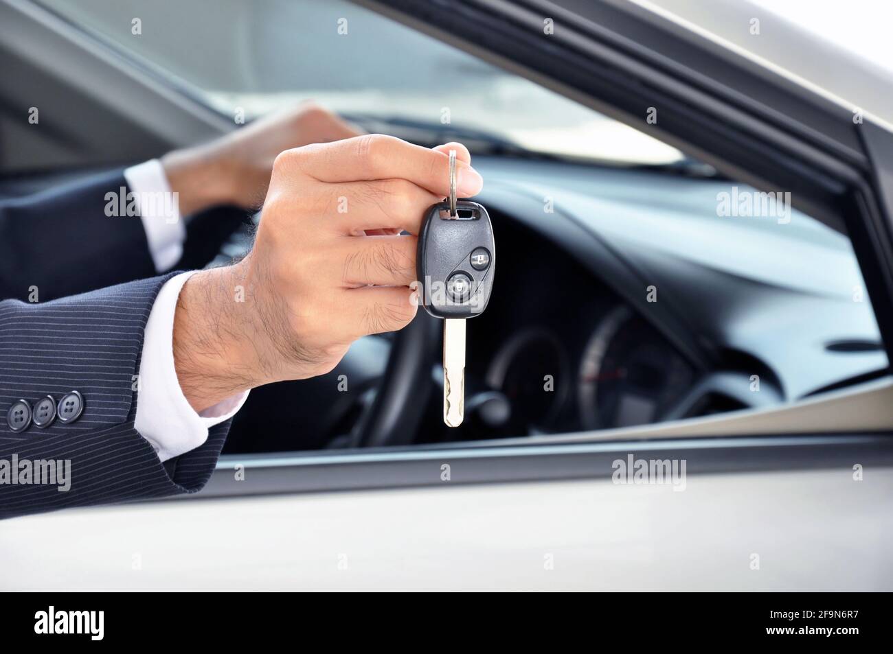 Hand holding a car key - car sale & rental business concept Stock Photo ...