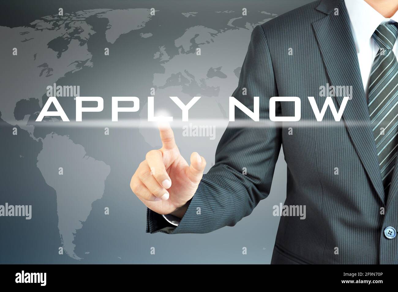 Businessman hand touching APPLY NOW sign on virtual screen Stock Photo