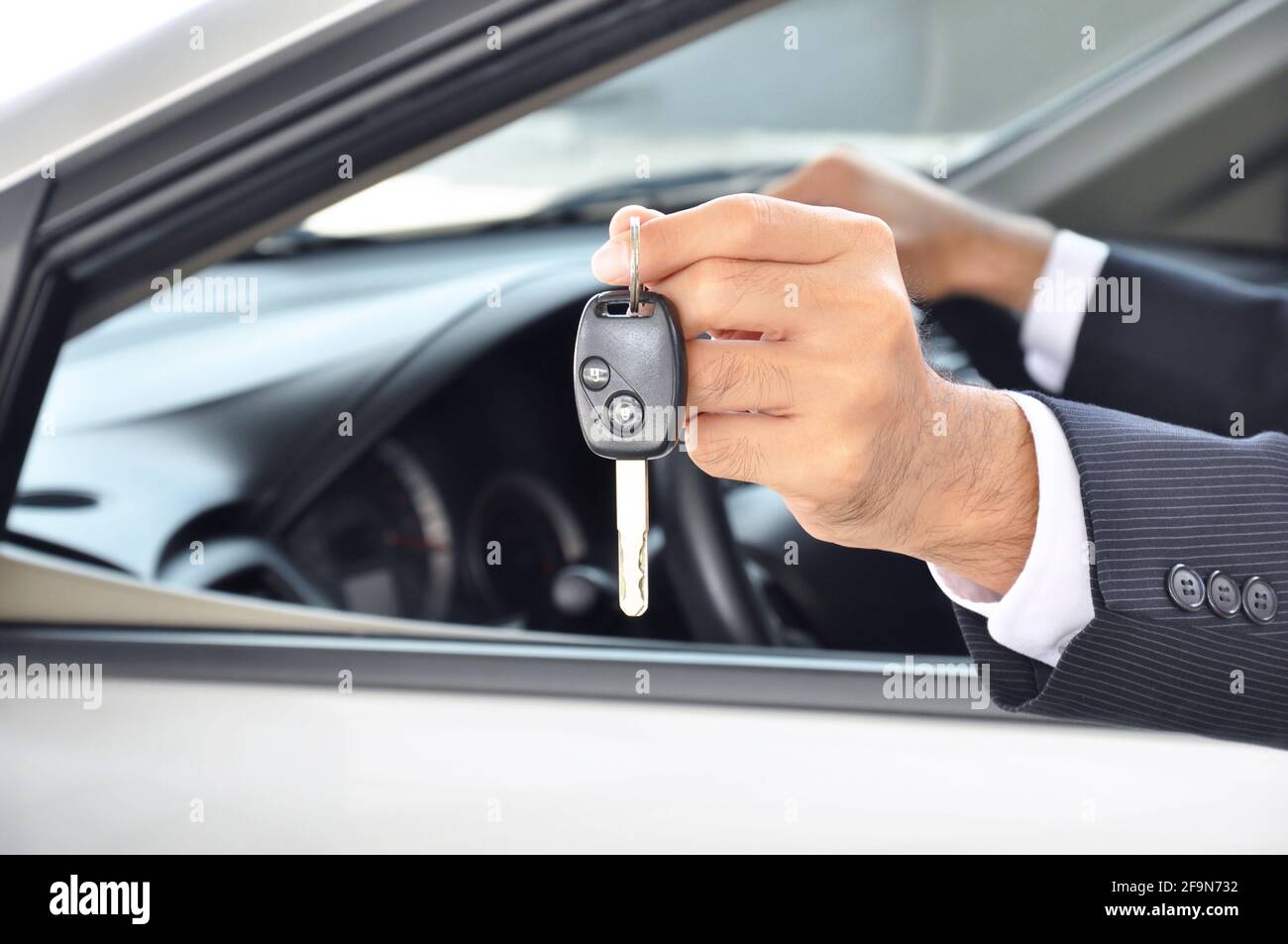 Hand holding a car key - car sale & rental business concept Stock Photo ...