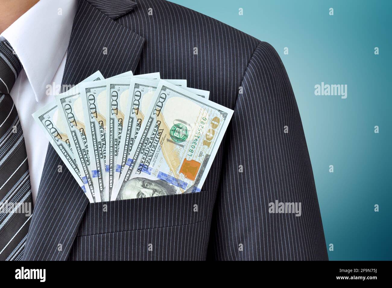 Money in businessman suit pocket  - United States dollars (USD) Stock Photo