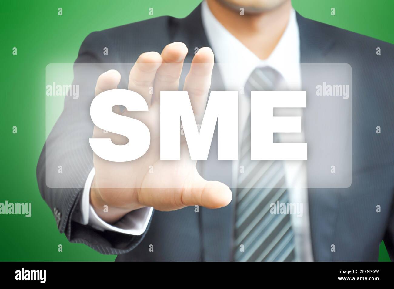 Businessman hand holding virtual screen with SME sign Stock Photo