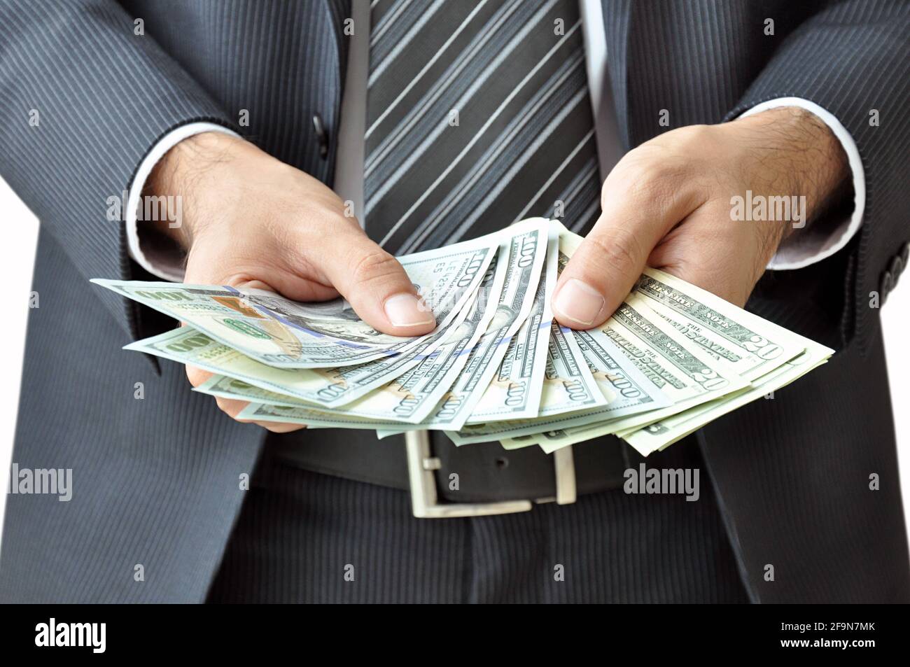 Businessman hand holding money - United States Dollars (or USD) Stock Photo
