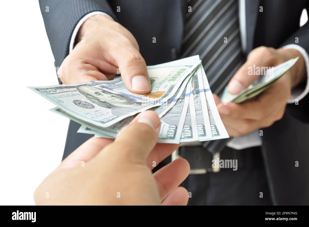 Hand giving money - United States Dollars (or USD) Stock Photo