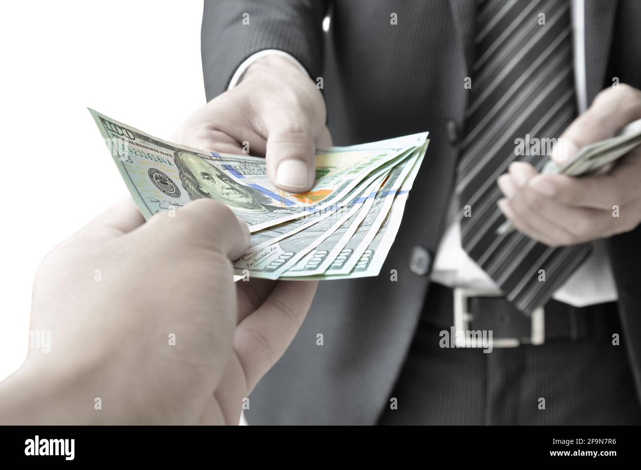 Hand giving money - United States Dollars (or USD) Stock Photo