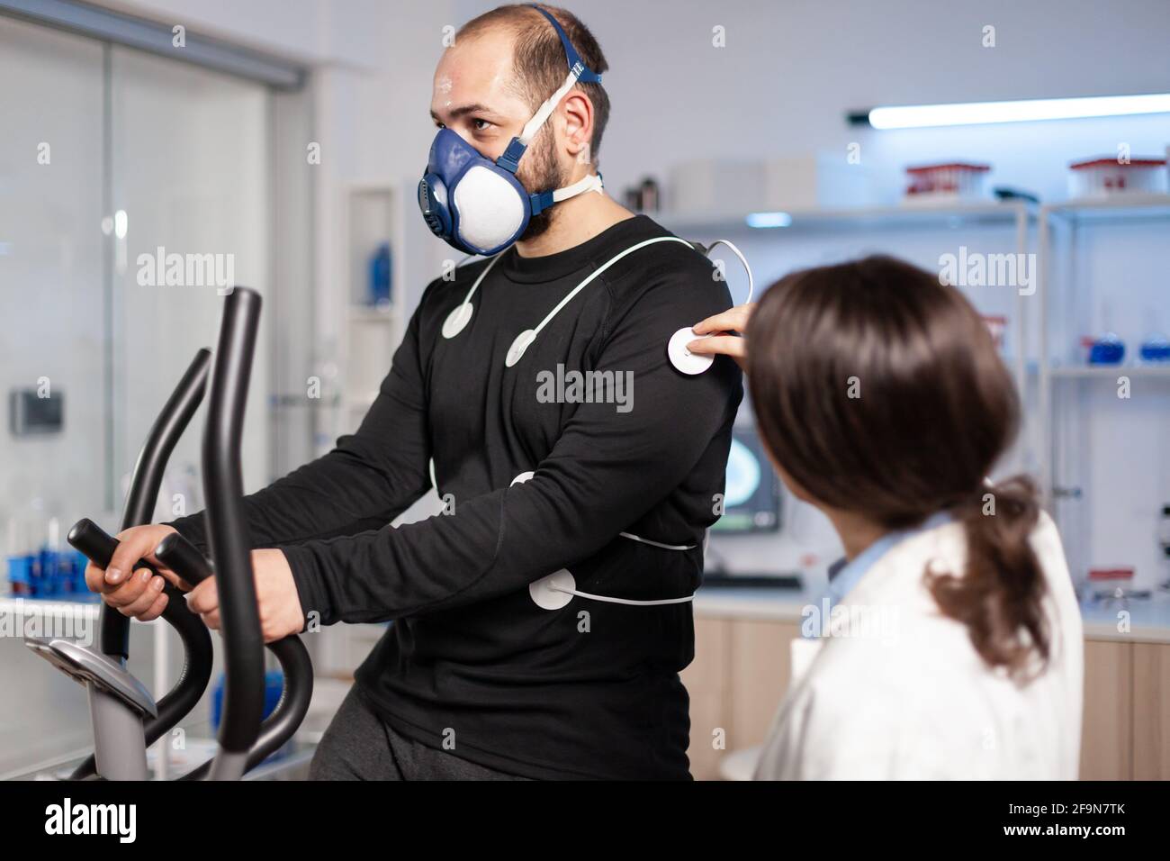 Sport researcher in test examination of athlete performance, monitoring