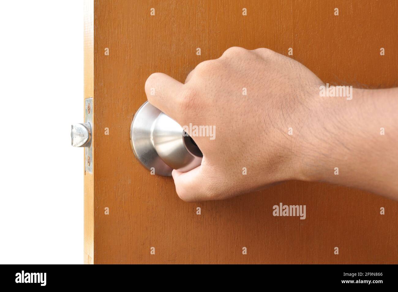 Hand turning the door knob Stock Photo Alamy