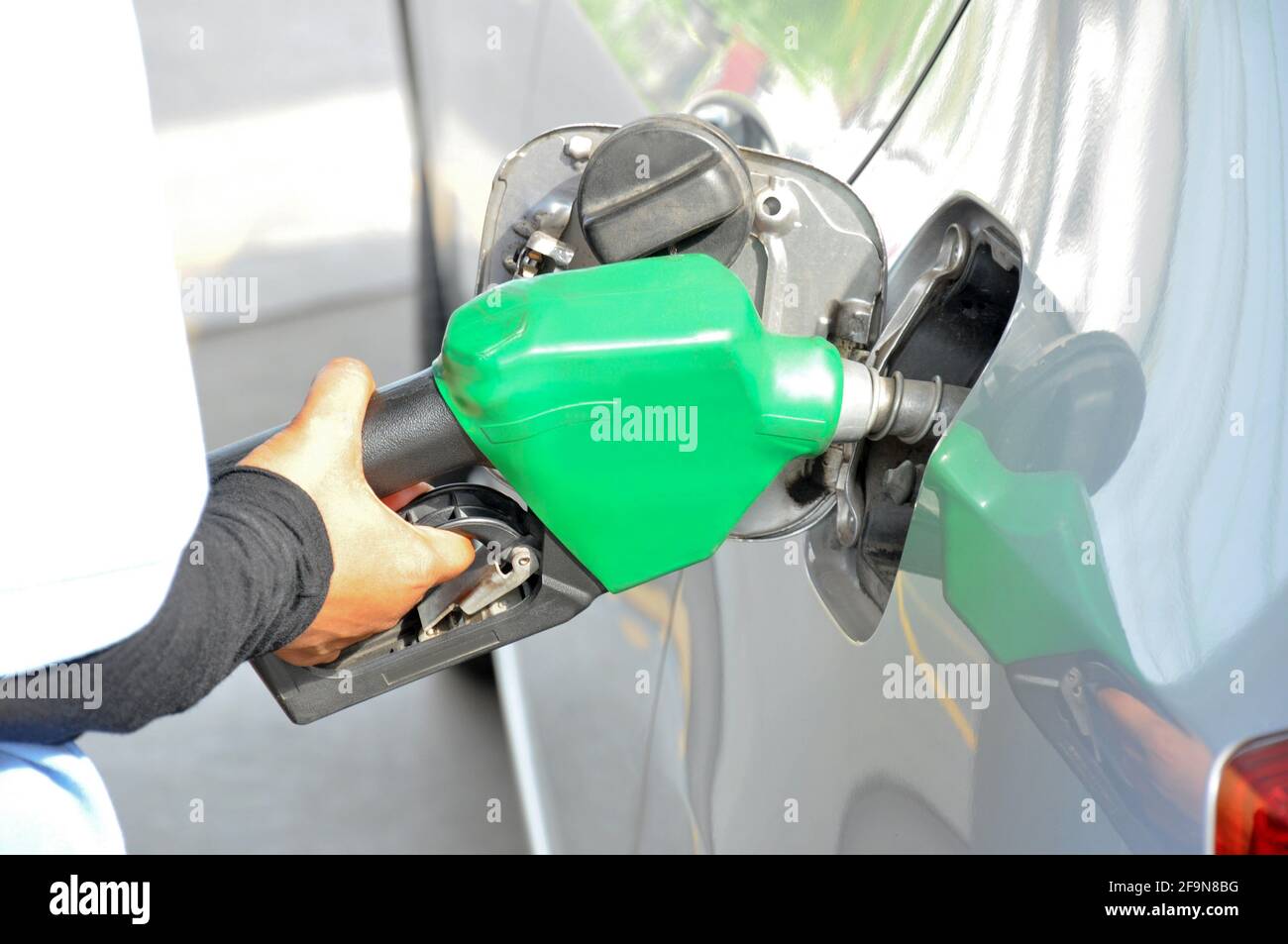 A man filling up the gas tank of a car Stock Photo