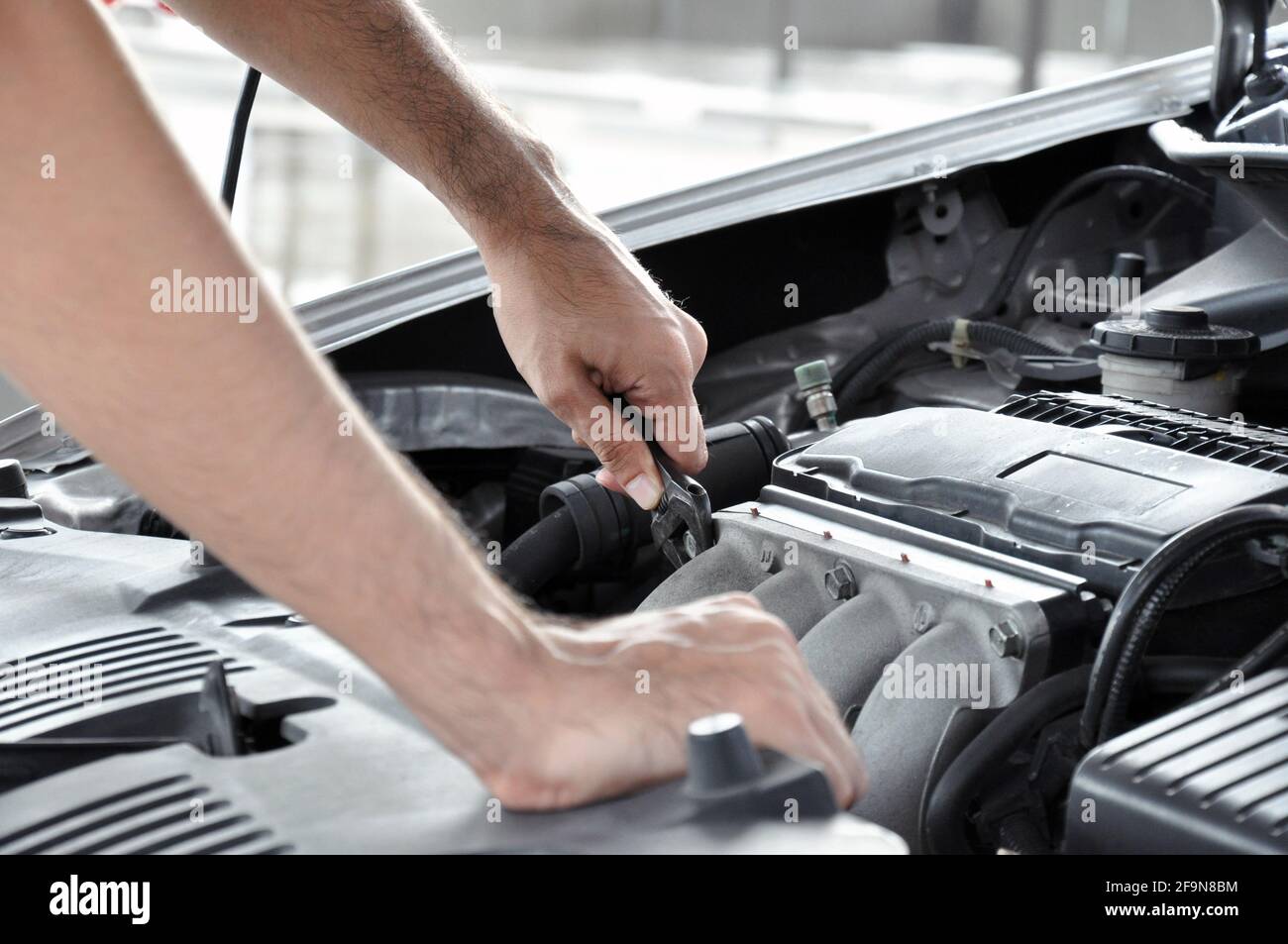 Mechanic checking car engine Stock Photo