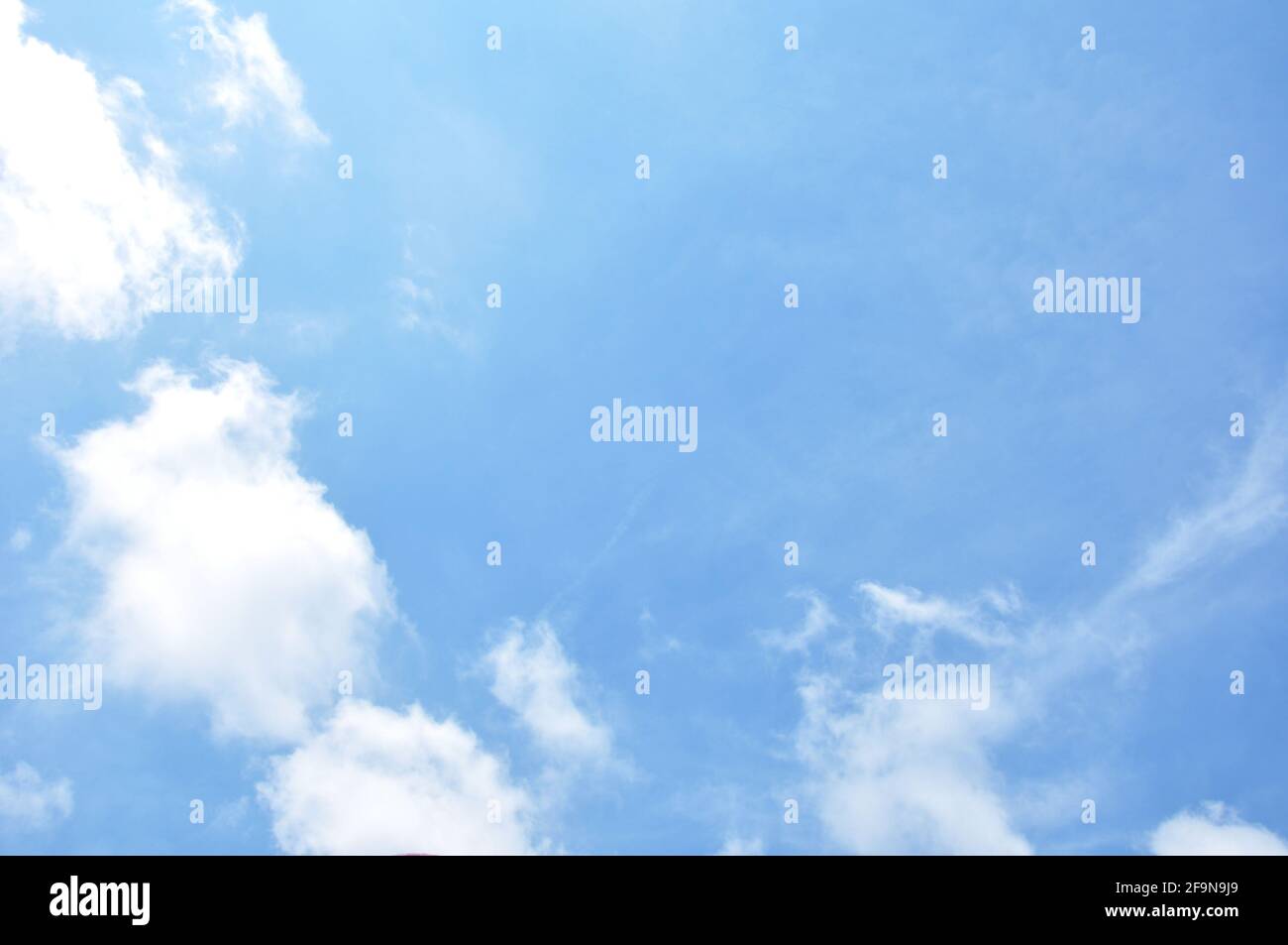 Blue sky with some clouds as natural background Stock Photo