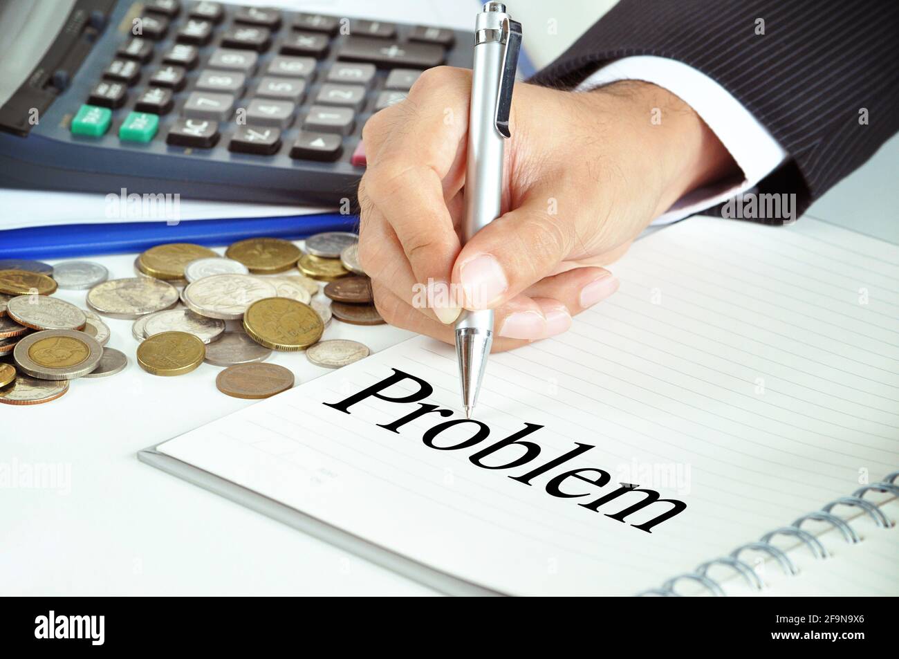 Hand with pen pointing to Problem word on the paper  - business & financial concept Stock Photo