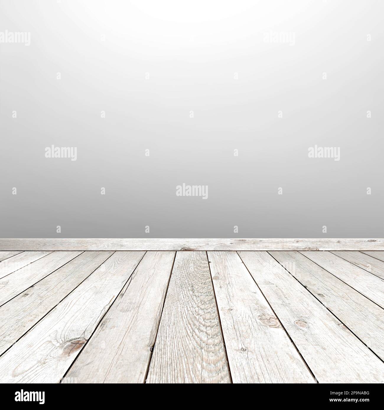 Empty room with faded wooden floor and white gray wall - can be used as background Stock Photo