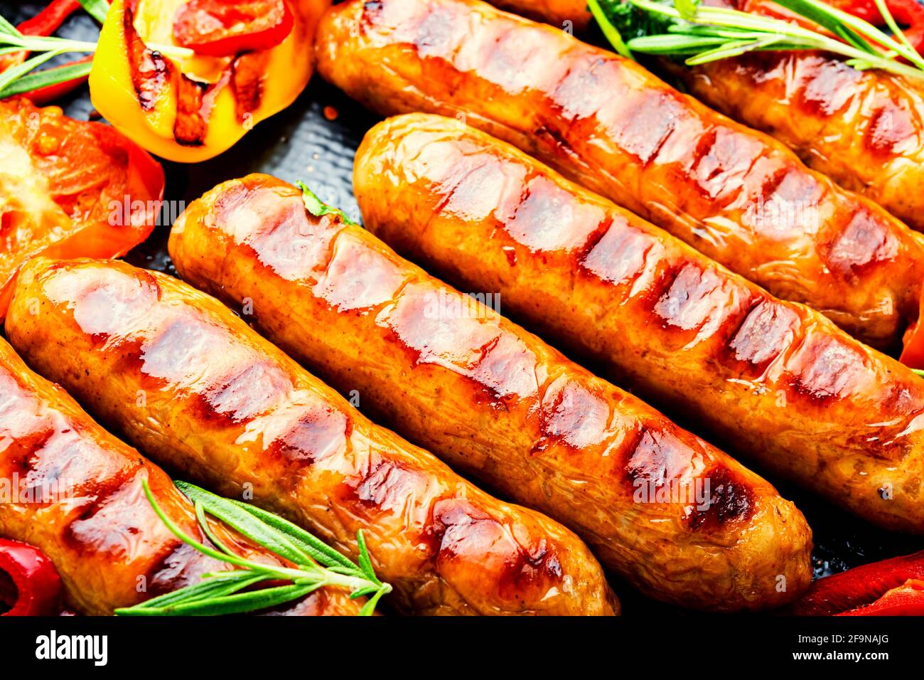 Grilled sausages on the plate.Fried sausages.Food background Stock