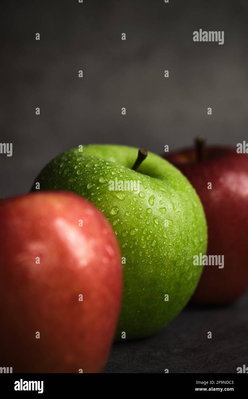three apples on a dark background Stock Photo