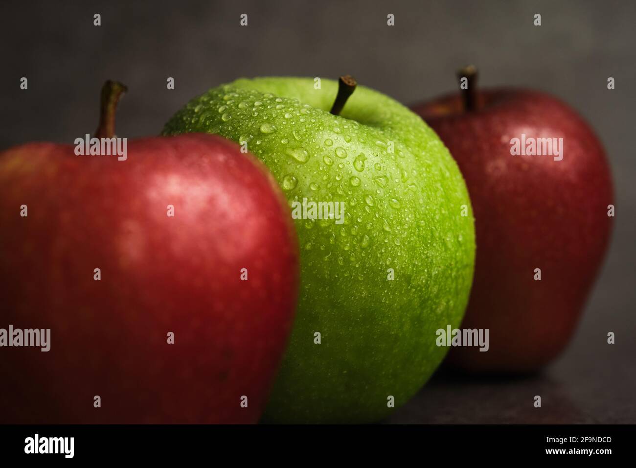 three apples on a dark background Stock Photo