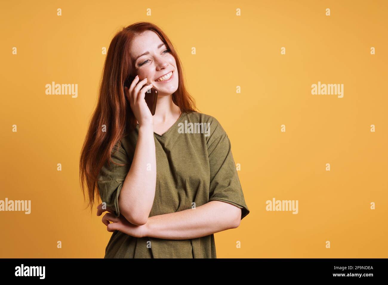happy laughing young woman talking on smartphone or mobile cell phone Stock Photo