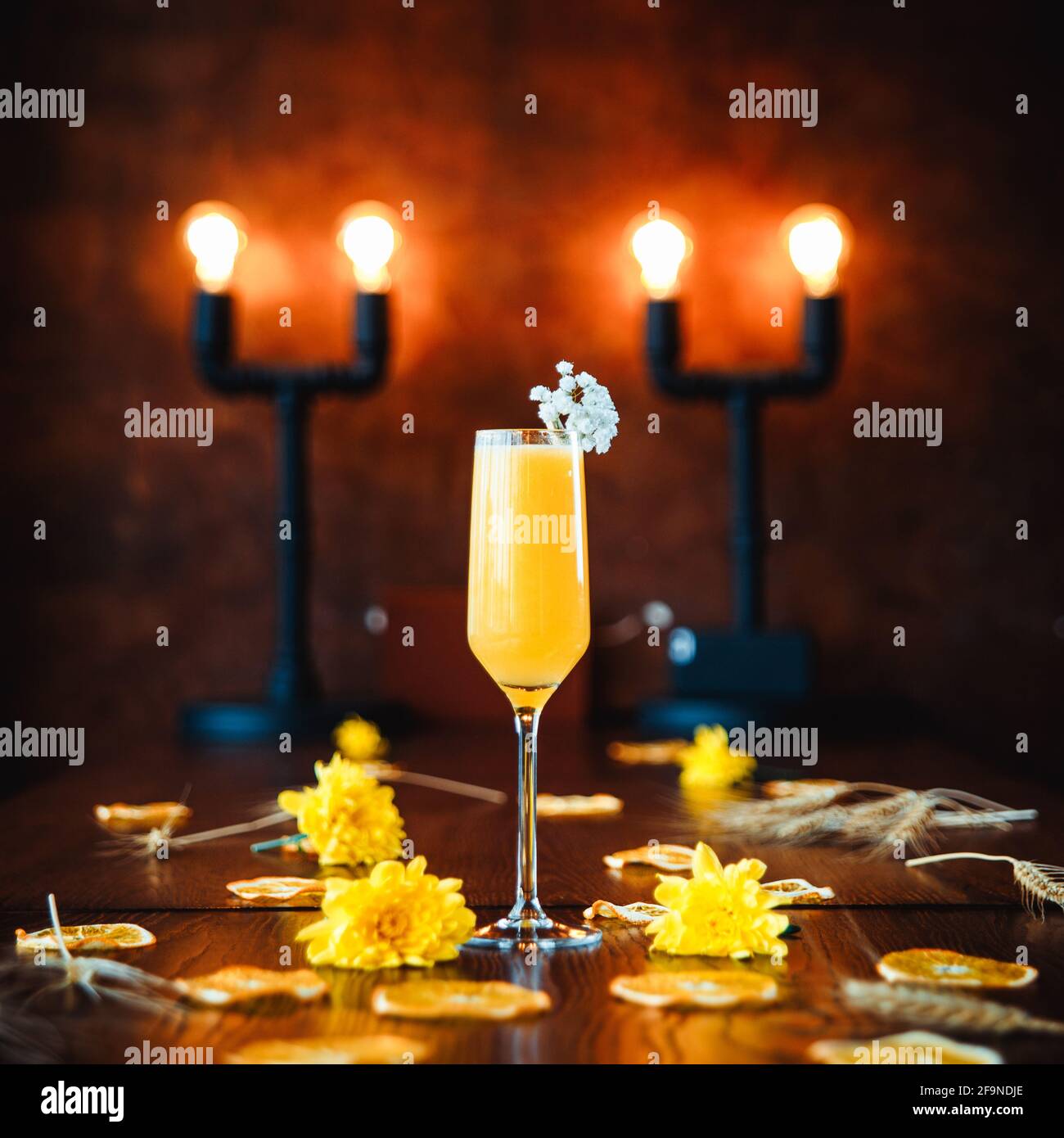 Glass of bellini cocktail on decorated table Stock Photo