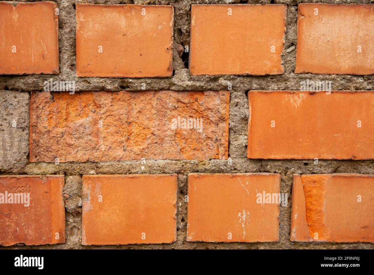 Old brick wall made of red bricks. Breaking down a wall falling apart