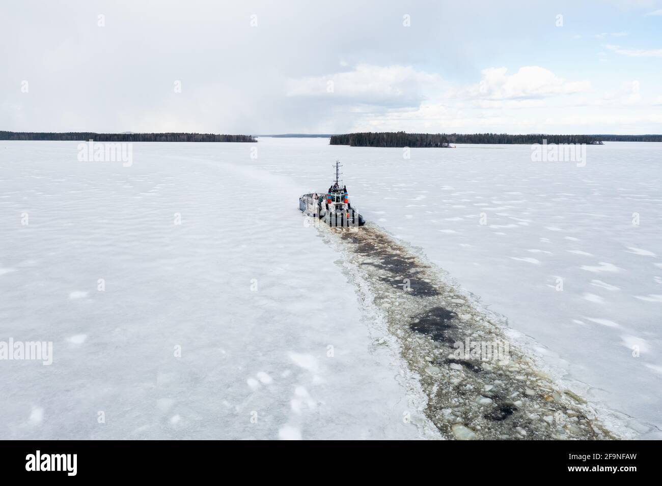 The icebreaker opens a shipping lane on an icy lake in Eastern Finland Stock Photo